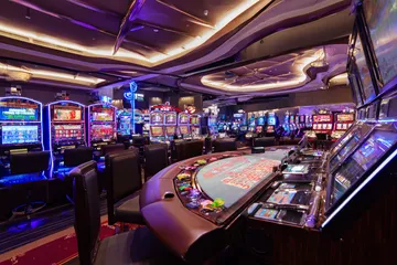 A glowing roulette wheel with cascading chips, symbolizing the engaging live and instant-win games available on 7U77.